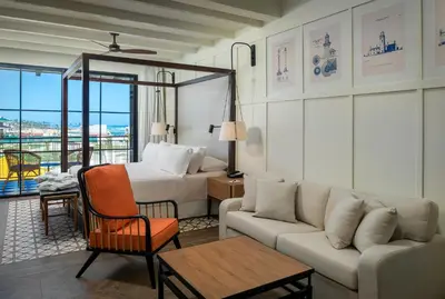 a hotel room with a bed and a couch at Ocean el Faro Resort - All Inclusive in Punta Cana