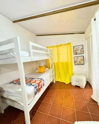 a bedroom with two bunk beds and a tile floor at Hotel Santo Cerro Natural Park in Santo Cerro