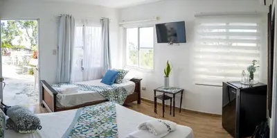 a hotel room with two beds and a tv at Hotel Santo Cerro Natural Park in Santo Cerro