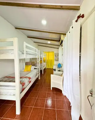 a bedroom with two bunk beds and a tiled floor at Hotel Santo Cerro Natural Park in Santo Cerro