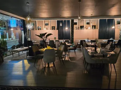 a dining room with tables and chairs and lights at Hotel Santa Clara in San Fernando de Monte Cristi