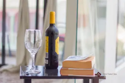 a bottle of wine and a glass on a table at Hotel Santa Clara in San Fernando de Monte Cristi