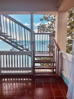 a balcony with a view of the ocean at Apartamentos Magallanes Bayahibe in Bayahibe