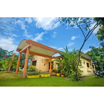 a house with a gambrel roof at Casa Villa Anacahuita in Jarabacoa