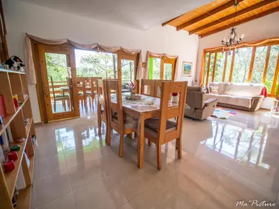 a dining room with a table and chairs at Mi Hogar Jarabacoa in Jarabacoa