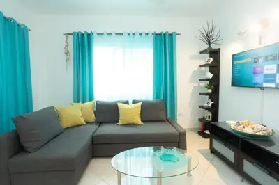a living room with a couch and a glass table at Las Terrenas, La Fenice, Playa Popy in Las Terrenas