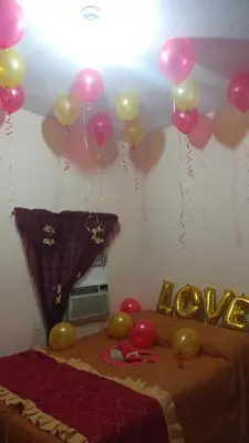 a room with balloons on the ceiling and a bed at Apartahotel carla in Boca Chica