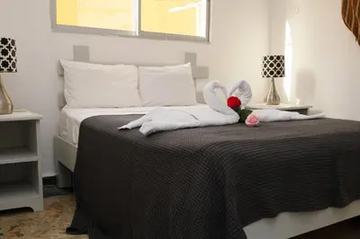 a bedroom with a bed with two stuffed animals on it at Aparta-Hotel Villa Baya in Bayahibe