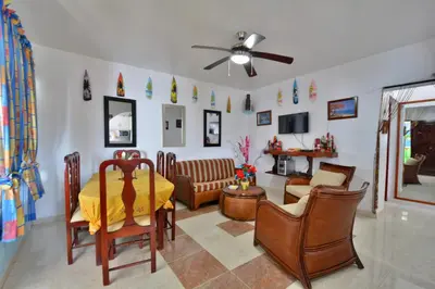 a living room with a yellow table and chairs at Villa Alégria in Santa Bárbara de Samaná