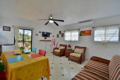 a living room with a yellow table and a couch at Villa Alégria in Santa Bárbara de Samaná
