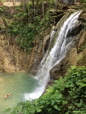 a waterfall in the middle of a pool of water at Casa Caracol Los Farallones in Cabrera