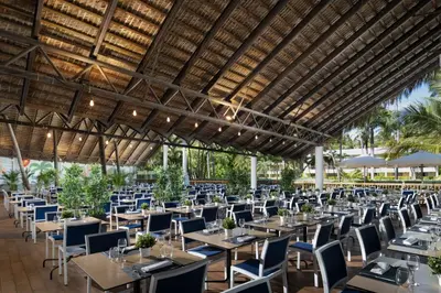 a group of tables and chairs in a restaurant at Impressive Punta Cana - All Inclusive in Punta Cana
