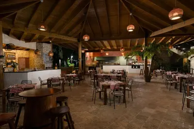 a restaurant with tables and chairs in a room at Impressive Punta Cana - All Inclusive in Punta Cana