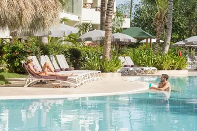 a woman in the swimming pool at a resort at Impressive Premium Punta Cana - All Inclusive in Punta Cana