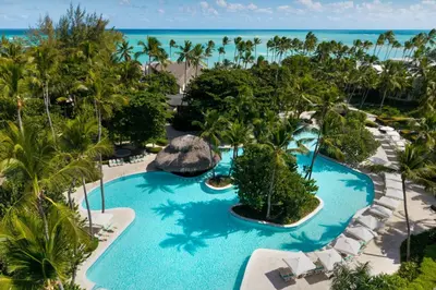 an aerial view of a resort with a pool and the ocean at Impressive Premium Punta Cana - All Inclusive in Punta Cana