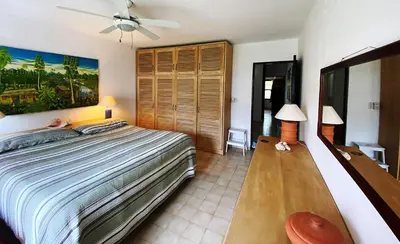 a bedroom with a bed and a ceiling fan at Cabarete Beachfront Condos at Nanny Estate C-5 in Cabarete