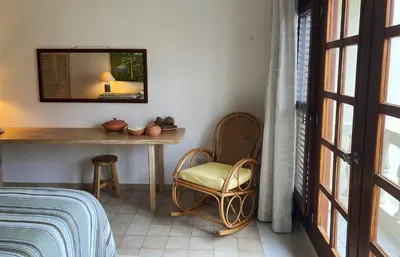 a bedroom with a table and a chair and a mirror at Cabarete Beachfront Condos at Nanny Estate C-5 in Cabarete
