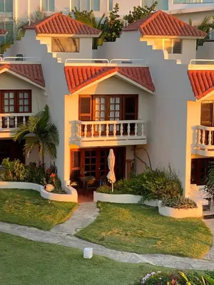 a house with red tile roofs and a yard at Cabarete Beachfront Condos at Nanny Estate C-5 in Cabarete