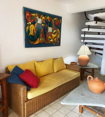 a living room with a couch and a painting on the wall at Cabarete Beachfront Condos at Nanny Estate C-5 in Cabarete