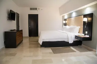 a hotel room with a bed and a television at Radisson Hotel Santo Domingo in Santo Domingo