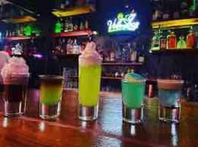 a group of drinks sitting on top of a bar at Cerca del Mar, Obelisco Hembra y Zona Colonial in Santo Domingo