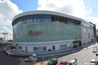 a large building with a x factor sign on it at Cerca del Mar, Obelisco Hembra y Zona Colonial in Santo Domingo