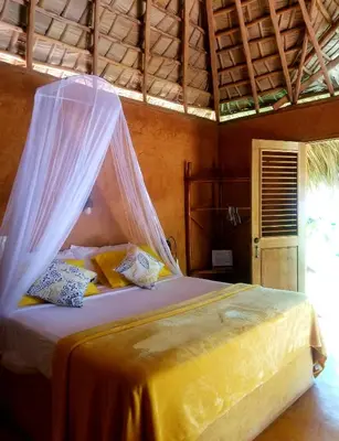 a bedroom with a bed with a mosquito net at Solazul in Las Galeras