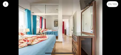 a bedroom with a bed and a dresser and a mirror at Villa Vista azul Sosua in Sosúa