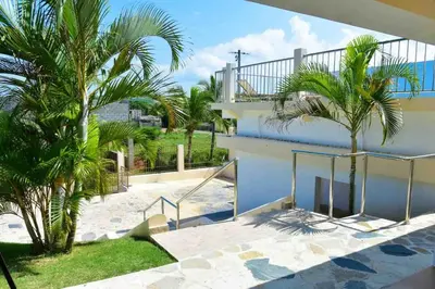 a view from the balcony of a house with palm trees at Villa Vista azul Sosua in Sosúa