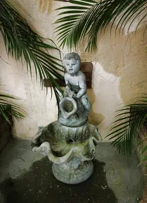 a statue of a boy sitting on top of an elephant at Hotel Aluge in Santo Domingo