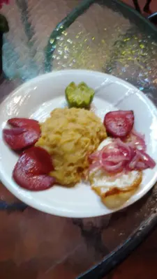 a plate of breakfast food with eggs and strawberries at Hotel Aluge in Santo Domingo