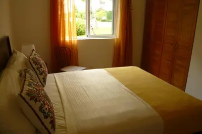 a bedroom with a large bed with a window at Pez 106 in Bayahibe