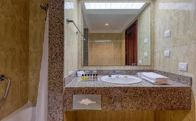 a bathroom with a sink and a mirror at Senator Puerto Plata in San Felipe de Puerto Plata