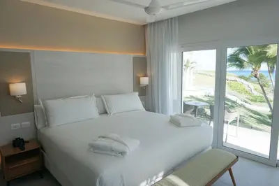 a bedroom with a large white bed and a window at Senator Puerto Plata in San Felipe de Puerto Plata
