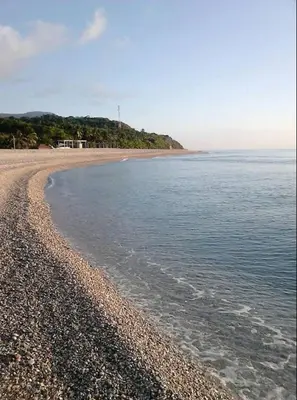 a beach with a rocky shore and the ocean at Hotel Vista Sur in Los Patos