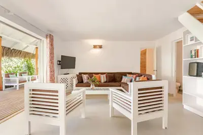 a living room with white chairs and a couch at Caribbean Beach Villa Playa Bonita Las Terrenas in Las Terrenas