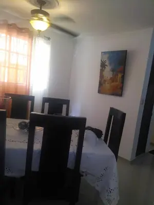 a dining room with a table and chairs and a ceiling fan at PARADISE 3 Cerro Altos in Santiago de los Caballeros