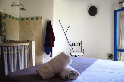 a bedroom with a bed with a towel on it at El Castillo in Las Galeras