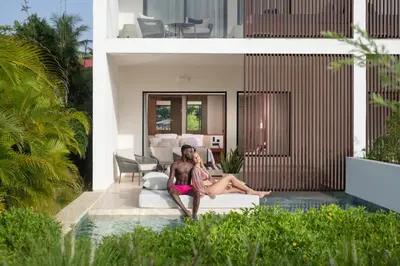 two women sitting on a couch in a house at Live Aqua Punta Cana - All Inclusive - Adults Only in Punta Cana