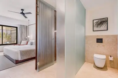 a bathroom with a bed and a toilet in a room at Live Aqua Punta Cana - All Inclusive - Adults Only in Punta Cana