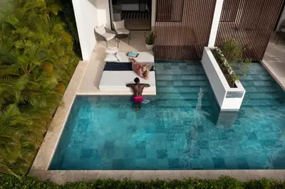 a person is standing in a swimming pool at Live Aqua Punta Cana - All Inclusive - Adults Only in Punta Cana