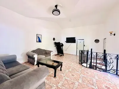 a living room with a couch and a table at HappiCasaRD & Holistic House in Sosúa