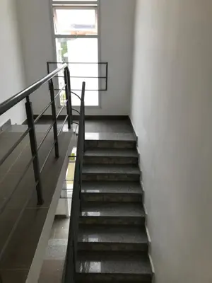 a staircase in a building with a window and a stair case at Aprtamento Deluxe Santiago, Residencial Palma Real R402 in Santiago de los Caballeros
