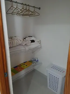 a small closet with two beds and a basket at Aprtamento Deluxe Santiago, Residencial Palma Real R402 in Santiago de los Caballeros