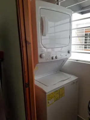a small refrigerator with a microwave on top of it at Aprtamento Deluxe Santiago, Residencial Palma Real R402 in Santiago de los Caballeros