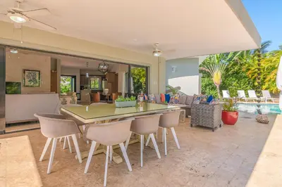 a kitchen and living room with a table and chairs at 883 Residencial Casa Linda in Sosúa