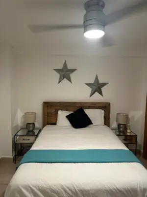 a bedroom with a bed with two stars on the wall at Beachfront, Juandolio in Juan Dolio