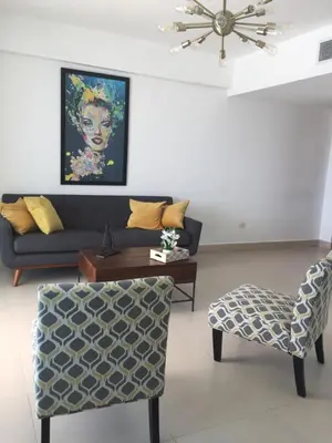 a living room with a couch and a chair at Beachfront, Juandolio in Juan Dolio