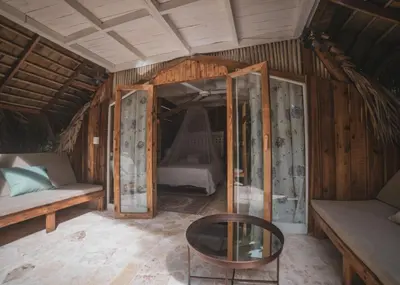 a room with a couch and a table and a bed at El Valle Lodge in El Valle