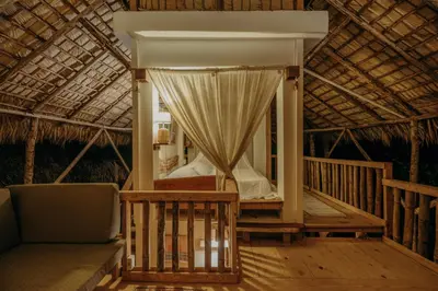 a porch of a resort with a bed and a chair at El Valle Lodge in El Valle